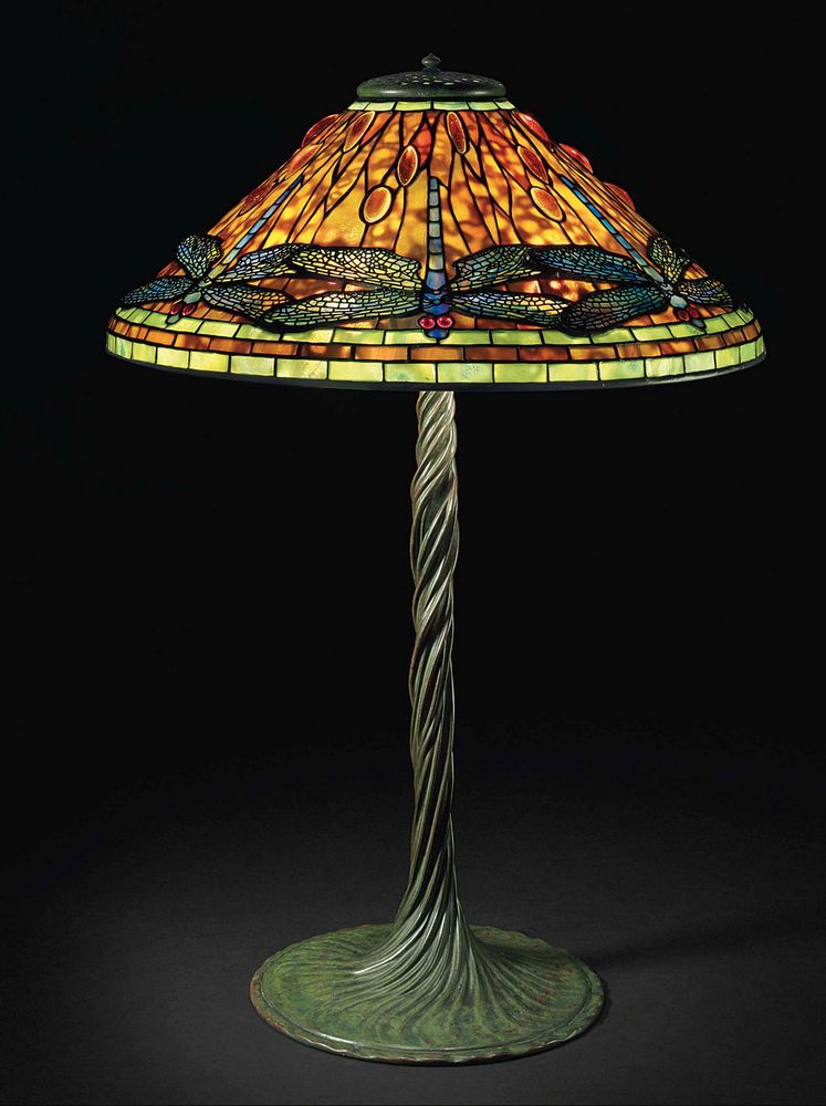 another plain jane dragonfly lamp. the deeply patina'd wrythen base is boldly asymmetrical and organic, spiraling upwards to greet the dragonfly leaded shade with jeweled medallions