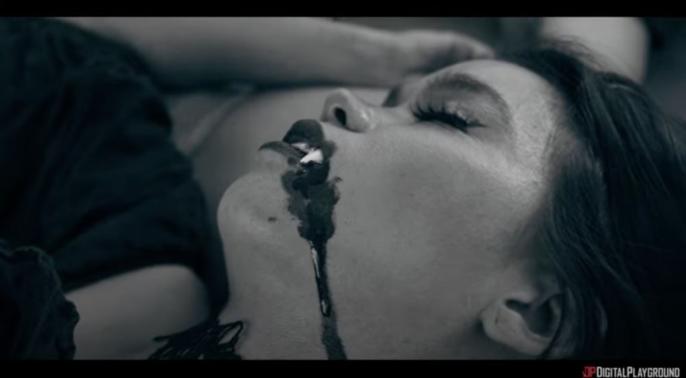 Angelina Moon as a dead vampire with fangs and blood dripping down her mouth.