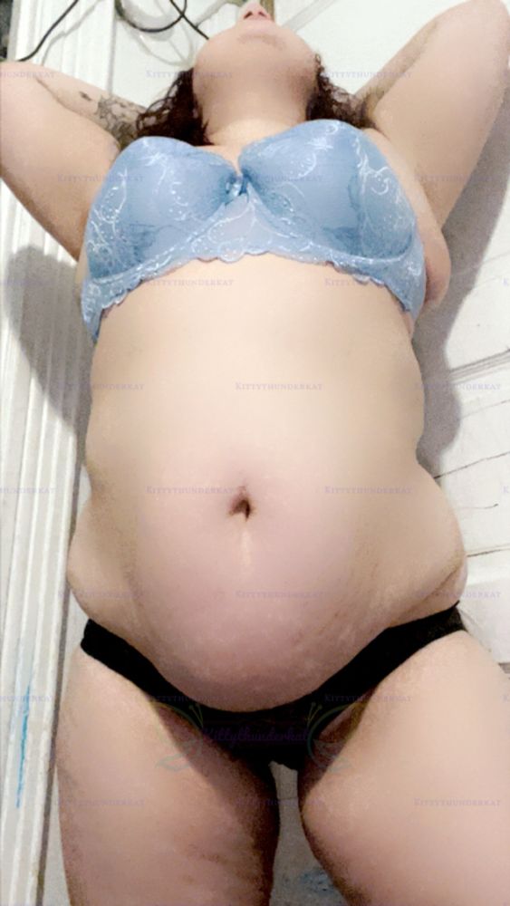 In a pinned position up, leaning back with my hands above my head, and my head up, I’m up against a door with a blue laced bra on and black panties showing off my bbw body 