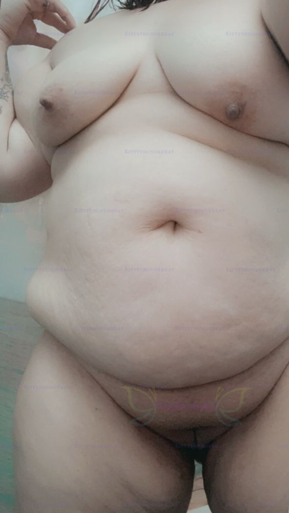 Completely naked showing off my bbw body with my tits showing and you can see my shaved pussy and my chubby thighs 