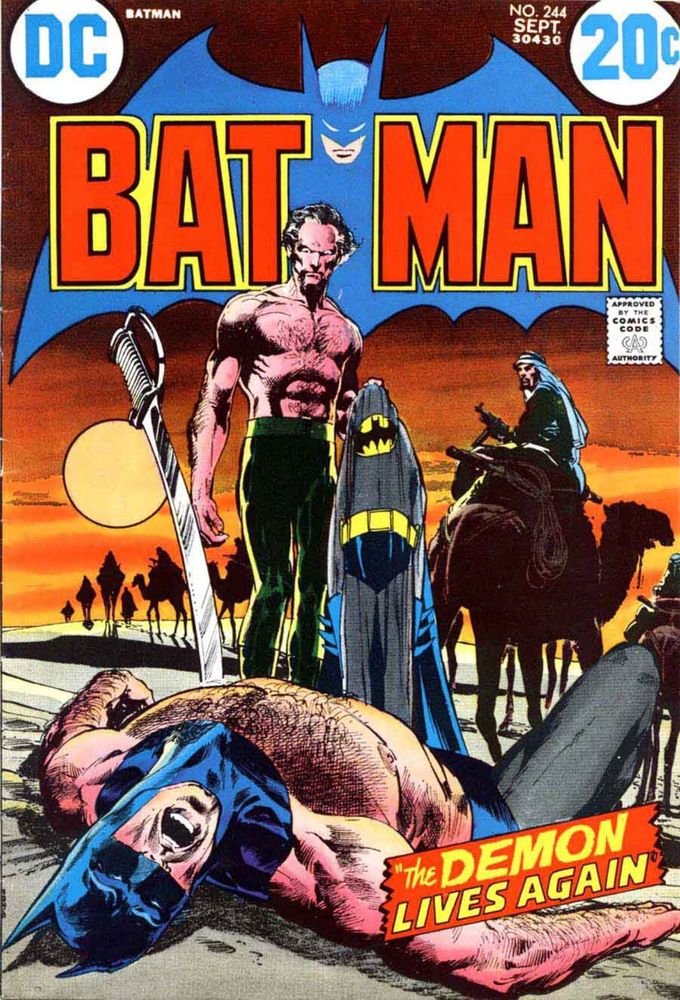 Man stands over the apparently dead Batman in the desert while an armed man riding a camel watches over the scene