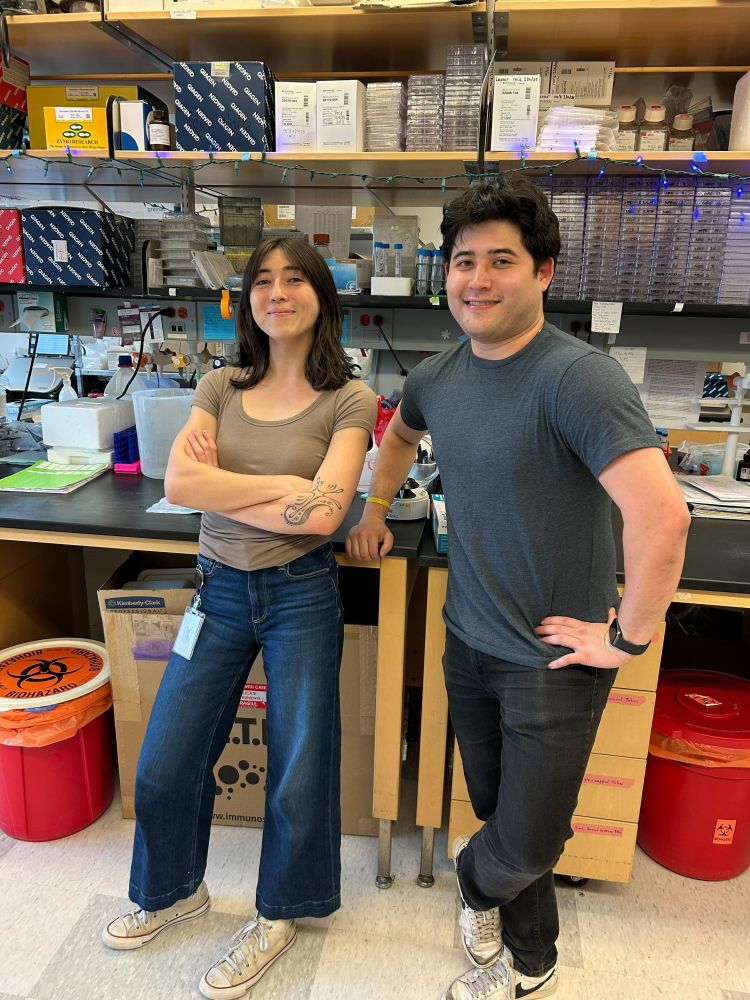 New UNC Microbiology & Immunology grad students Alex and Taras stand by a lab bench. They look confident and ready to tackle important questions about flavivirus pathogenesis.