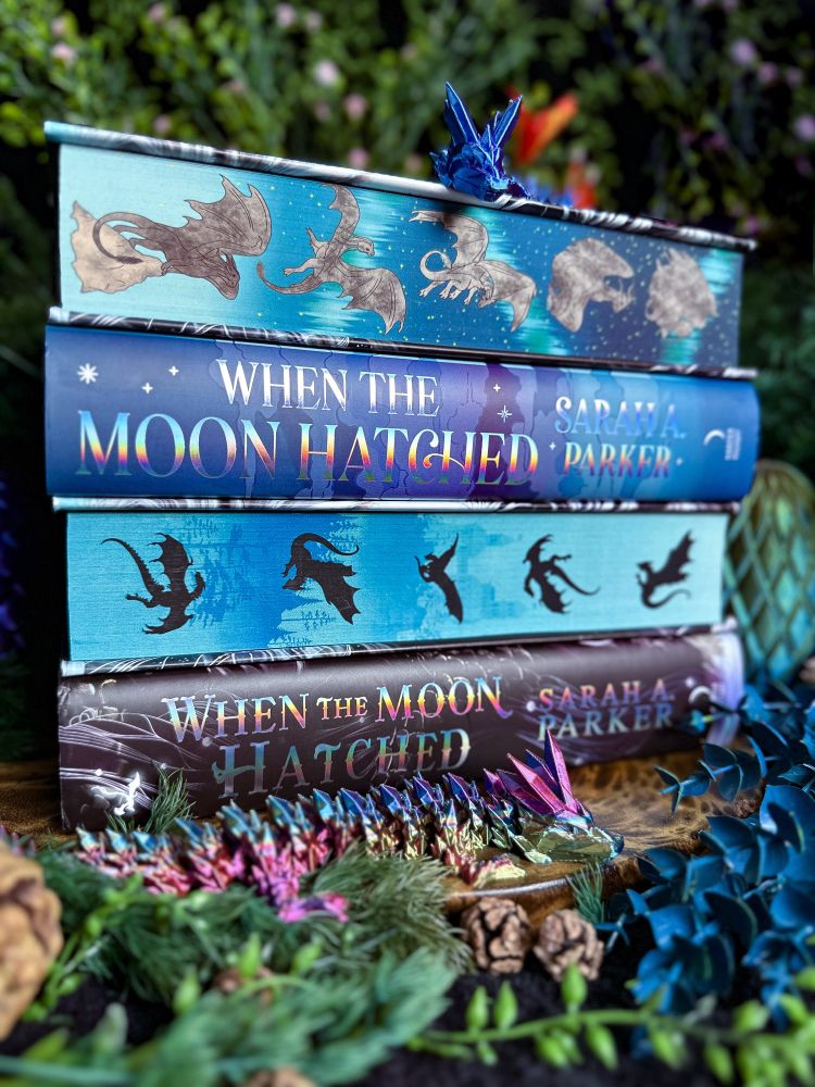 A close up of a stack of books with dragon sprayed edges