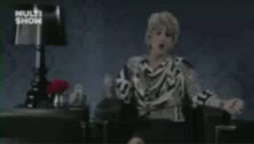 a blurred image of a woman sitting in a chair with a lamp in the background that says multi show