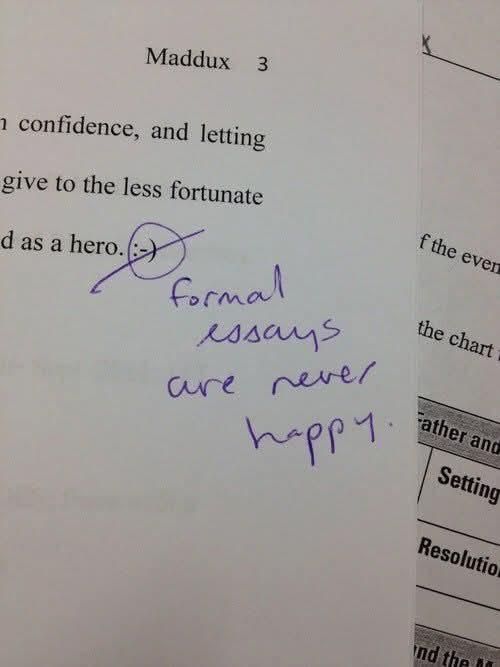 Close up photo of someone's essay for school that ends with a smiley face emoji, which is crossed out in purple pen by teacher with the note "formal essays are never happy"