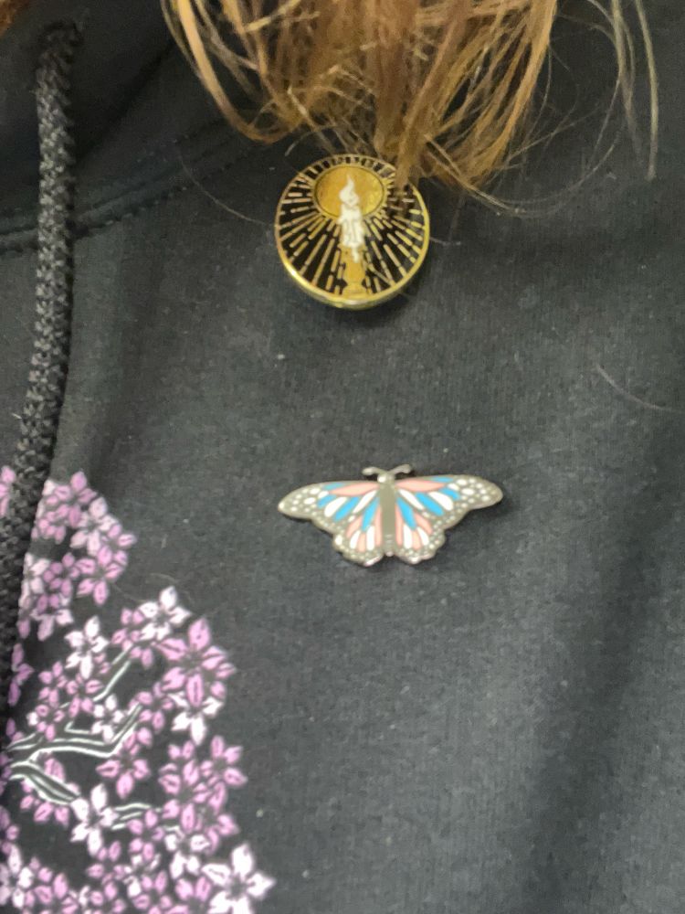 Close up on the butterfly pin and a candle pin