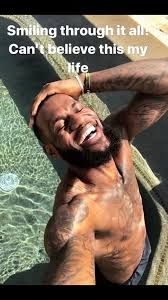 lebron james laughing in a pool with the text “Smiling through it all! Can’t believe this is my life”