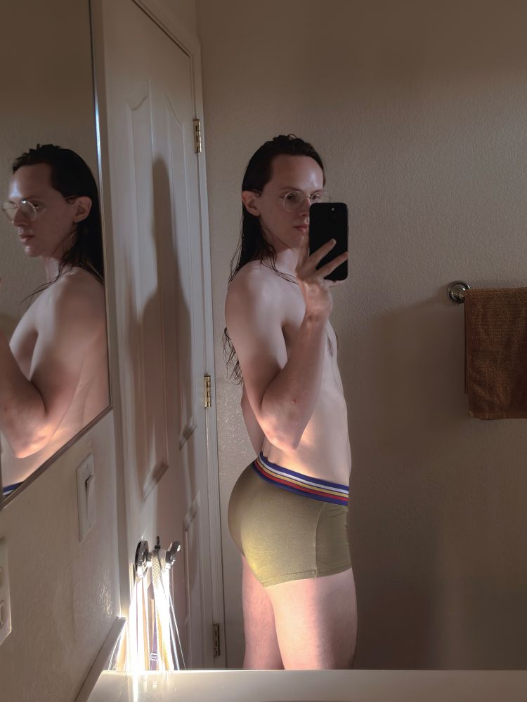 A mirror selfie of me in some green Bike trunk underwear, showing off the booty. The sun is illuminating my cheeks and thighs. 