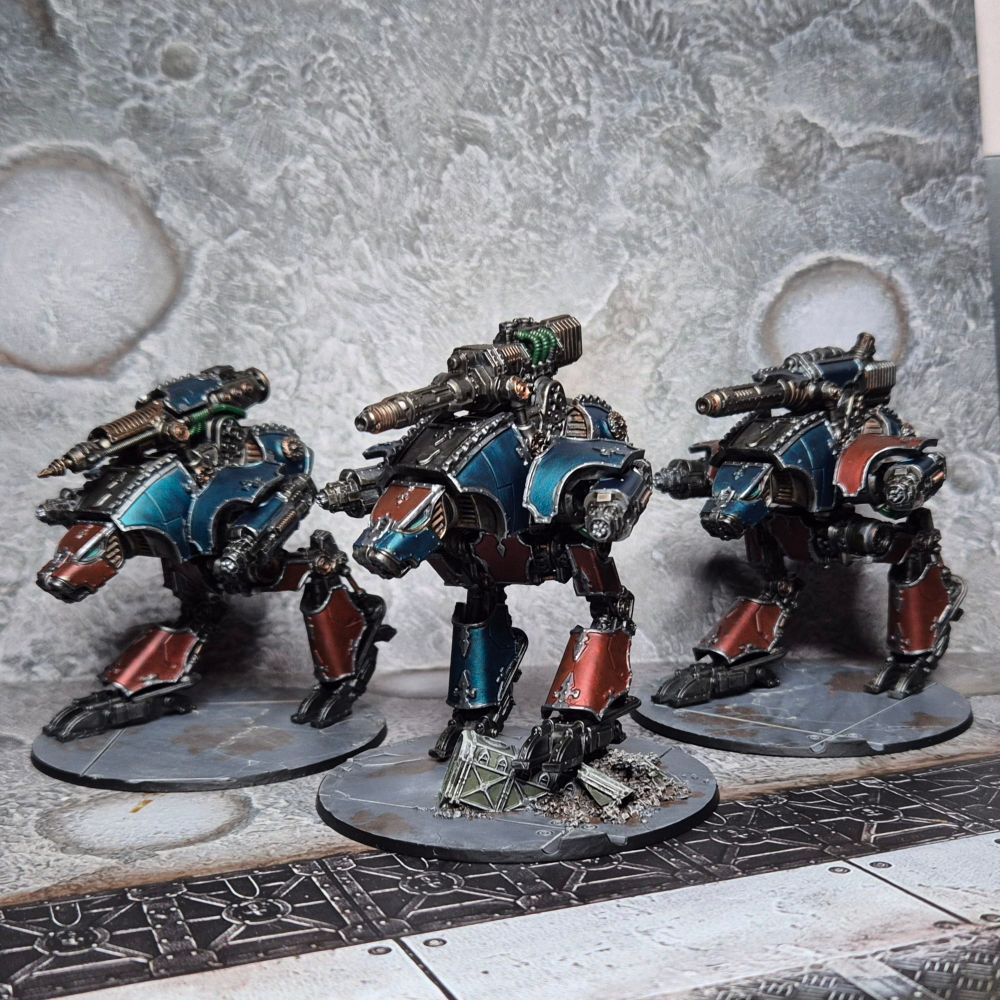 Three Dire Wolf titans in Legio Laniaskara colours for Adeptus Titanicus
