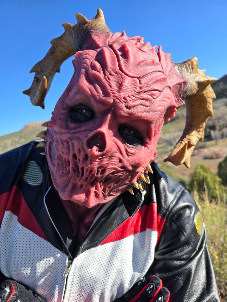 A Demon Silicone Mask and a White, Red and Black Motorcycle Riding Suit
