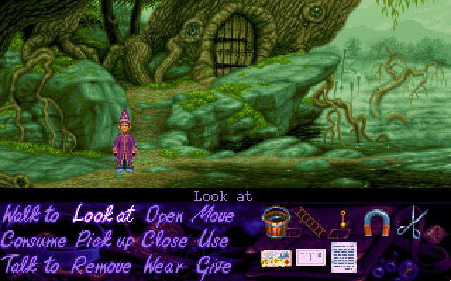 A door in a wonky tree surrounded by rock faces that leads to the swampling’s house in Simon the Sorcerer