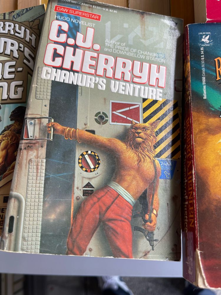 A book cover depicting a half man half cat closing a door to a room where he clearly just banged another half man hat cat