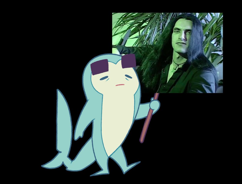 A shark figurine holding a sign with a dark haired man plastered to it