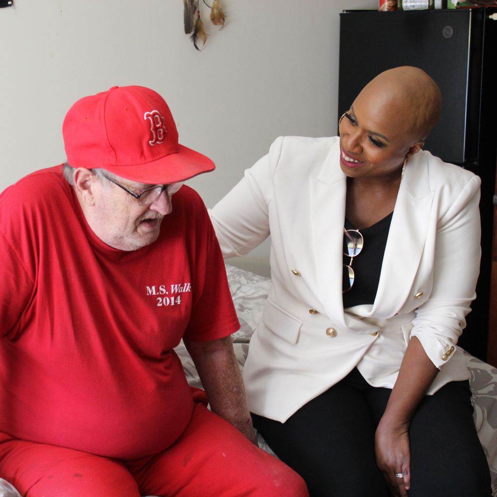 Rep. Ayanna Pressley meets with Joe, one of 10 formerly homeless Veterans living in the Envision Bank Home for Veterans in Randolph.