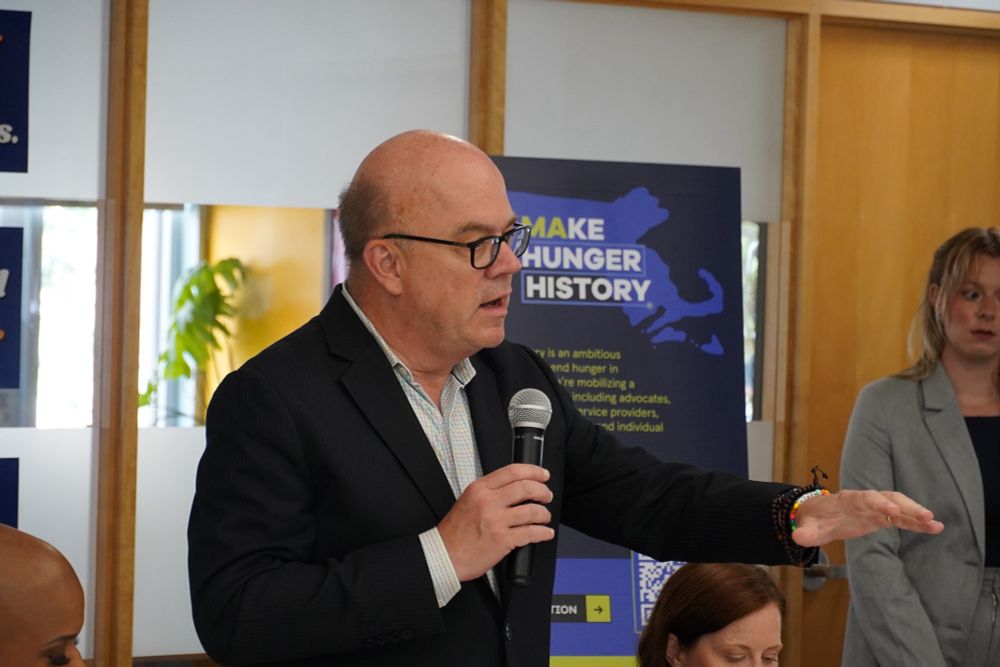Rep. Jim McGovern holds a mic as he delivers remarks during a listening session in East Boston. 