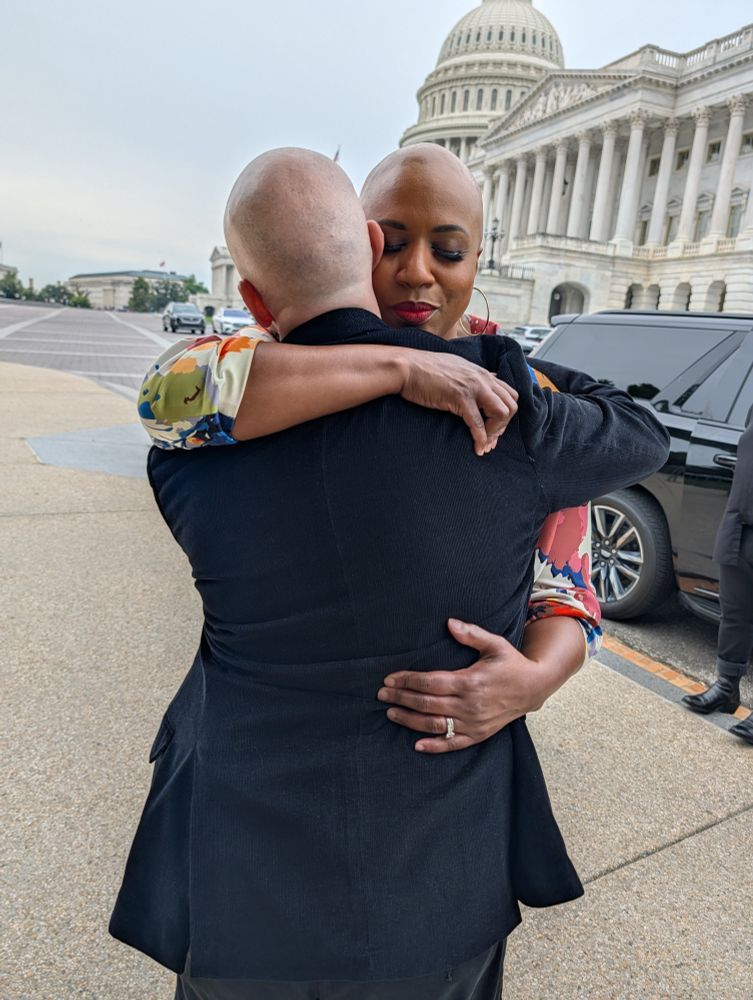 Rep. Pressley shares an embrace with an educator who would be impacted by a government shutdown. 
