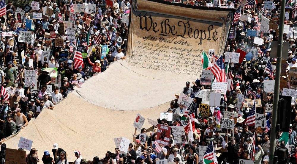 Demonstrators carry a massive replica of the U.S. Constitution at the No Kings protest in downtown Los Angeles 