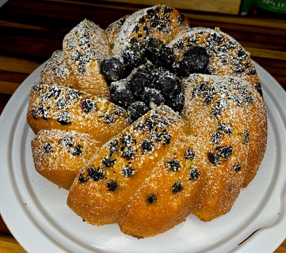 Lemon blueberry cake with intact powdered sugar.