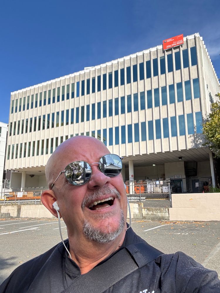 Scott looks kookoo with an old 1970s or 80s office building behind him, says Scott… “Isn’t this where Jaimie Sommers, the Bionic Woman worked for Oscar at OSI? I could SWEAR!