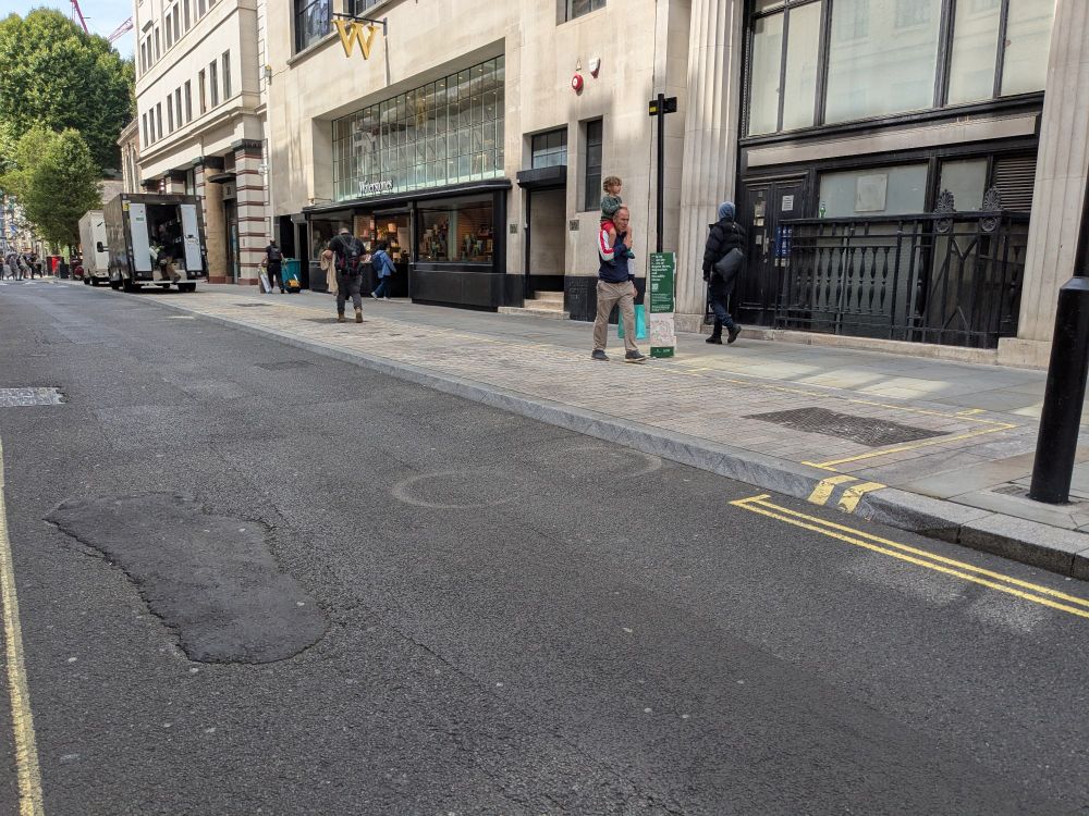 Photo of a loading bay inset within the footway, with splay kerbs allowing access by loading vehicles.