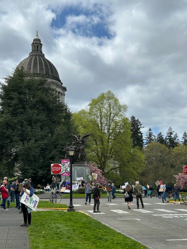 Anti Trump protestors walk the streets in front of the Washington state capitol on April 19, 2025