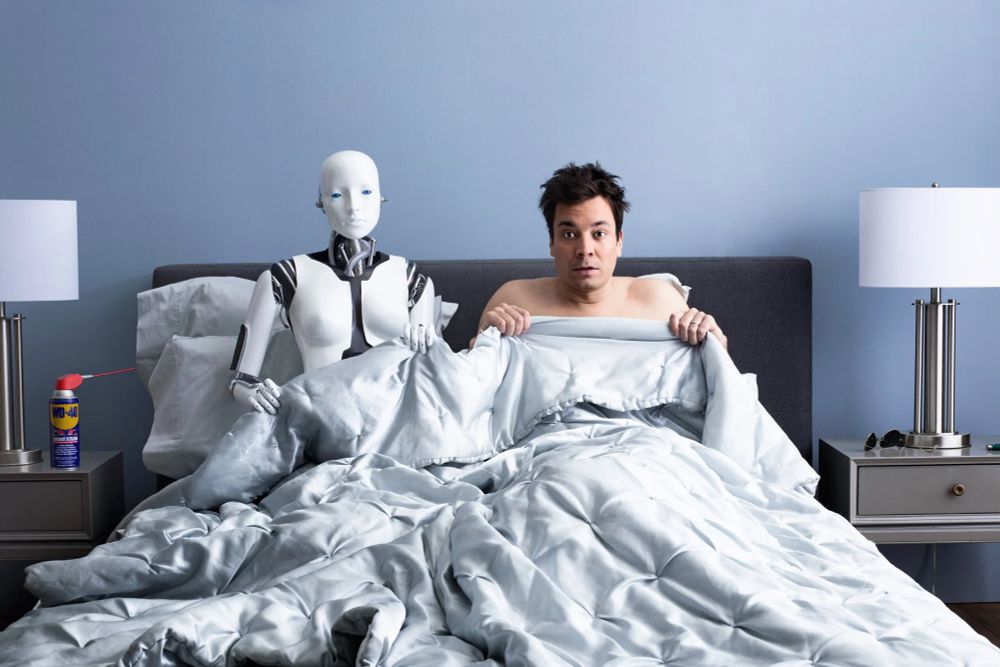 Jimmy Fallon and the robot Baxter pictured in bed, from a 2012 Wired magazine article.