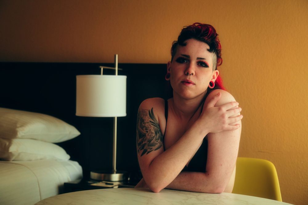 Bex sitting at a table in a hotel room