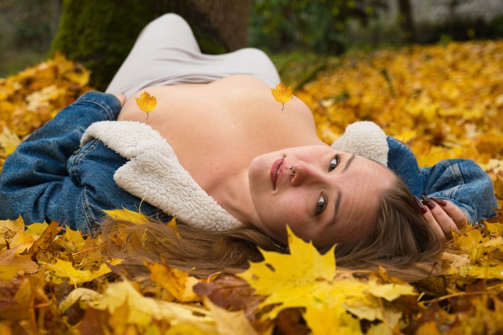 Honey in Western wear in a field of fallen autumn leaves 