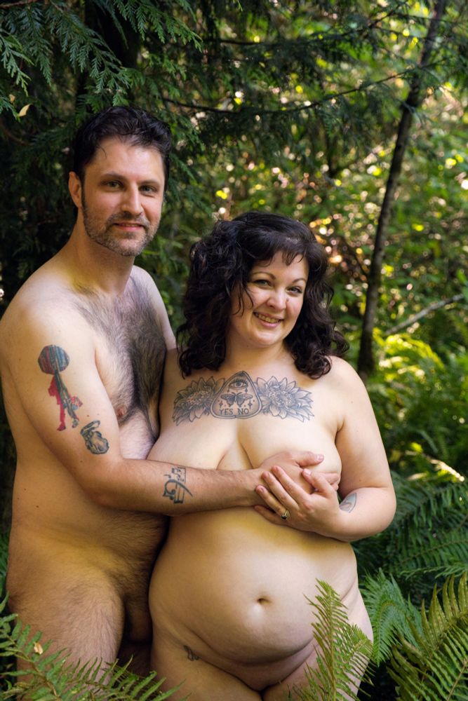 Hades Flambe and Luci Ferocious standing naked amongst the ferns in the forest