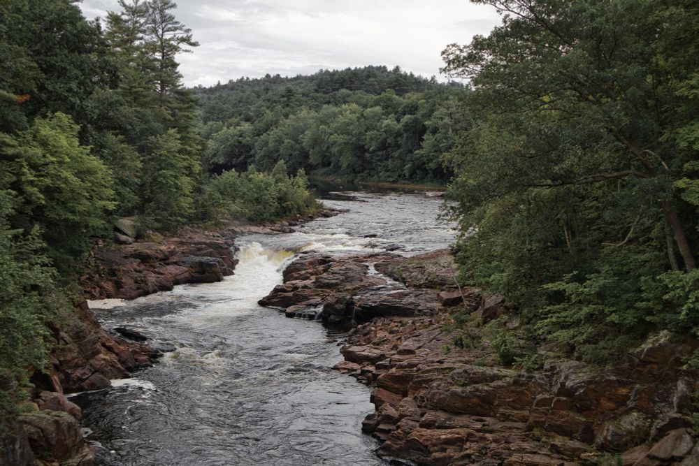 Rockwell Falls on the Hudson. Framed by thick forest and ledge, the Hudson turns with fury as it drops into a gorge.