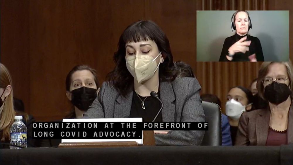 Senate hearing with speaker and audience all wearing high quality masks.