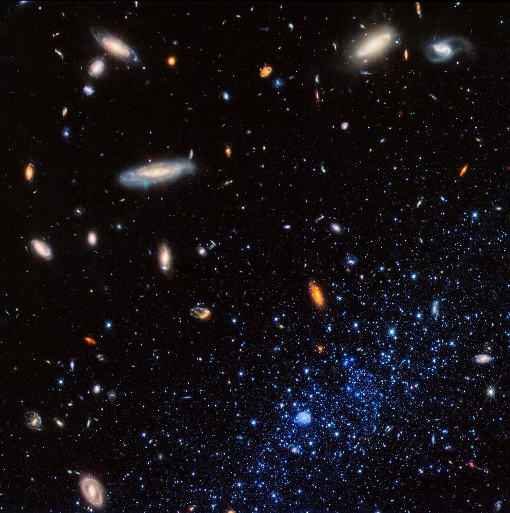 This image from NASA’s James Webb Space Telescope shows a portion of the Leo P dwarf galaxy (stars at lower right represented in blue). Leo P is a star-forming galaxy located about 5 million light-years away in the constellation Leo. A team of scientists collected data from about 15,000 stars in Leo P to deduce its star formation history. They determined that it went through three phases: an initial burst of star formation, a “pause” that lasted several billion years, and then a new round of star formation that is still continuing.