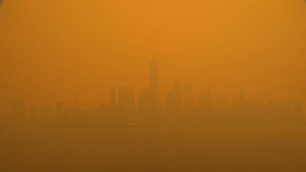 New York City's skyline on June 7, 2023, covered in orange wildfire smoke.