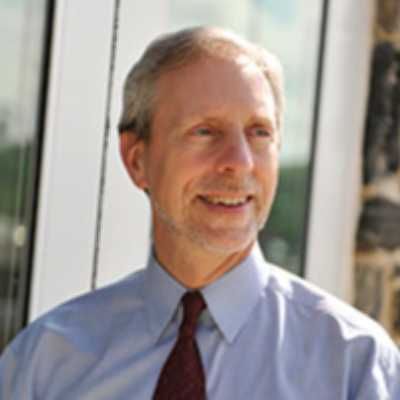 Image of Greg Cantori in a shirt and tie.