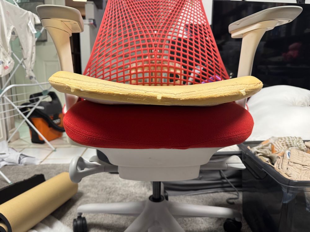 Old cushion placed on top of the new finished chair to show difference in support. Old cushion only slightly softer than a sheet of cardboard 
