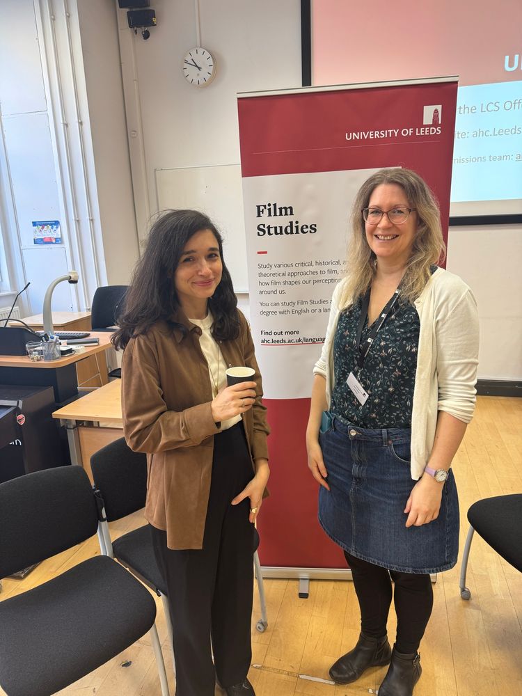 Two of our lecturers in Film Studies stand by their banner. 