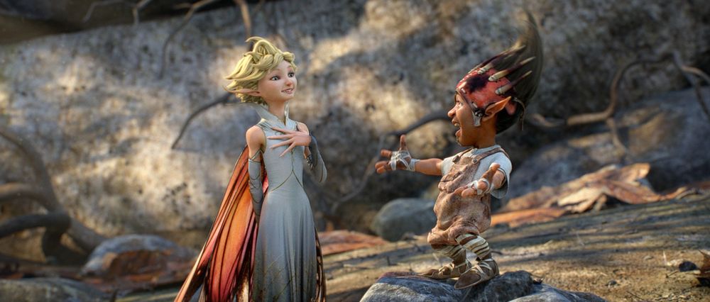 Dawn and Sunny talking in a rocky, woodland setting. Dawn has a hand over her heart and Sunny acknowledges her with a lively expression.