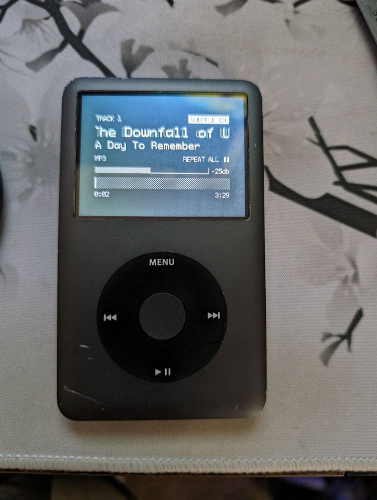 A black iPod Classic 7th gen, modded with Rockbox and a 128GB microSD. 
