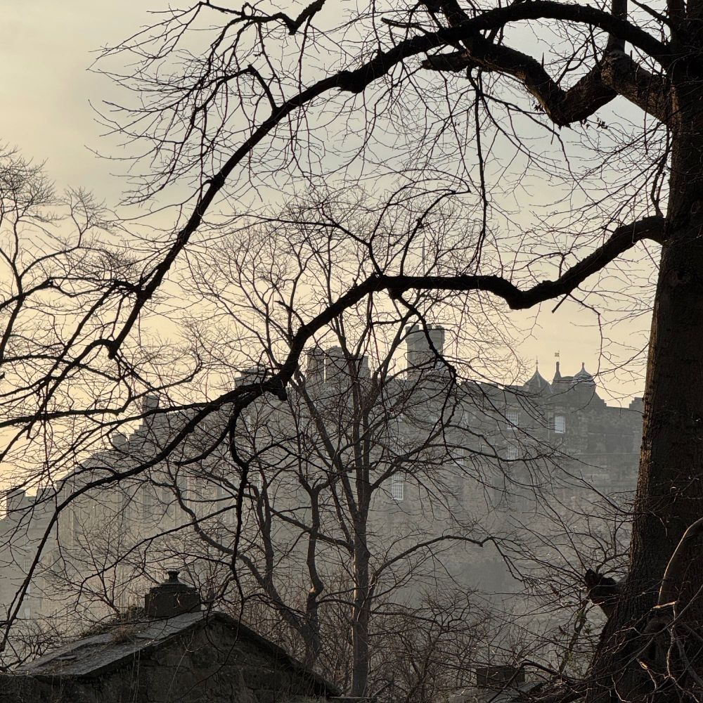 Looking over from Greyfrairs Kirkyard to Edinburgh Castle with a slight Haar (fog) and weak sun making an almost grey silhouette.  