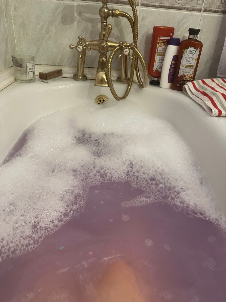how creative people bathe (picture of same bathtub, now with purple water and bubbles)