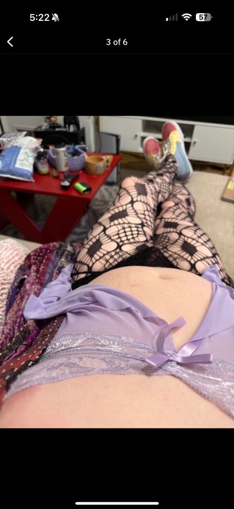 me in purple lingerie and fishnets with a nipple poking out