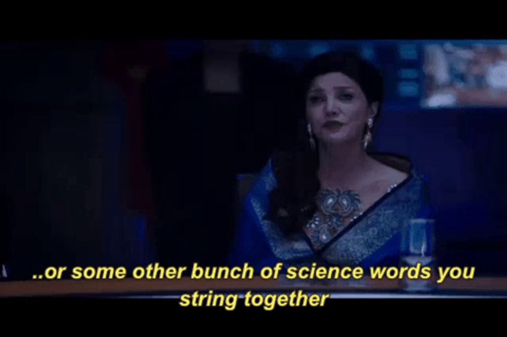 a woman in a blue saree is talking about science words