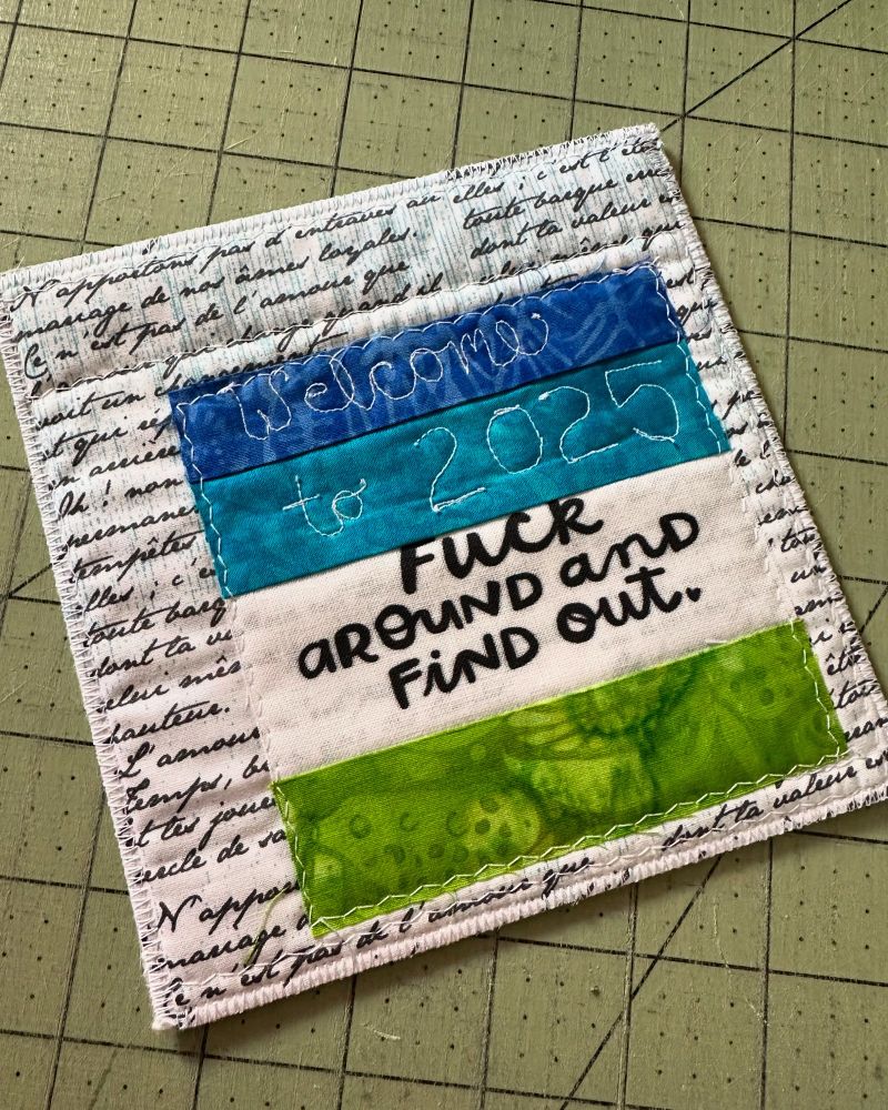 Small quilt that has the words welcome to 2025 fuck around and find out printed on it.
