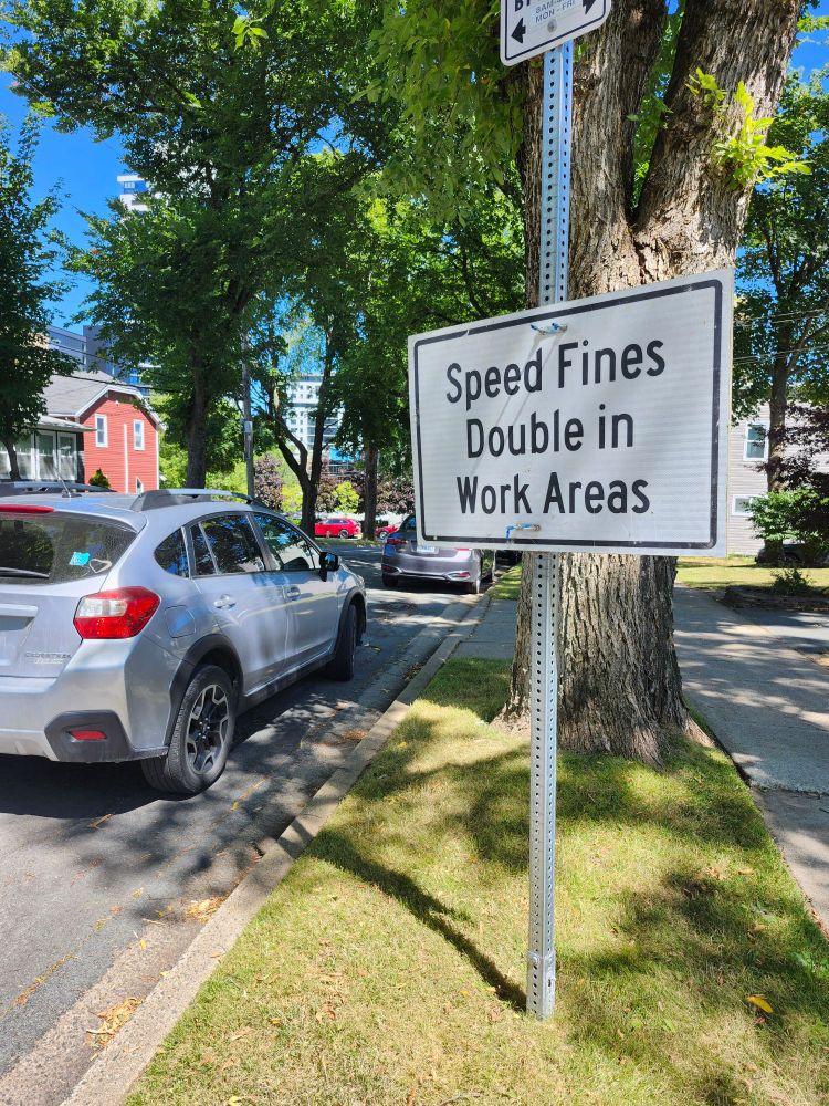 Temporary traffic sign attached to an existing sign post leaving sidewalk cleared

