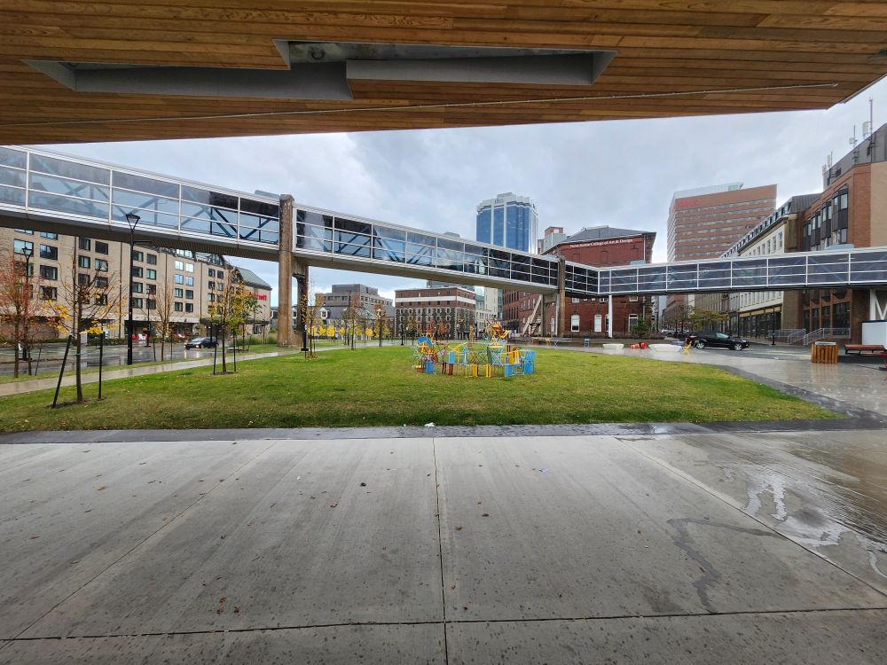 View of park and downtown buildings,  with shelter room in forefront 