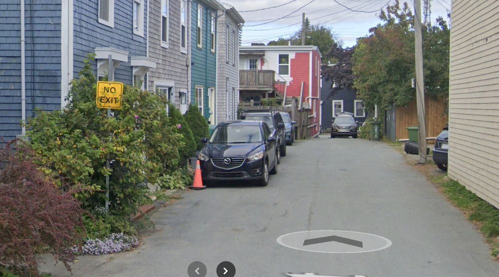 no exit sign on a street which is blocked for cars but not for pedestrians nor cyclists. 