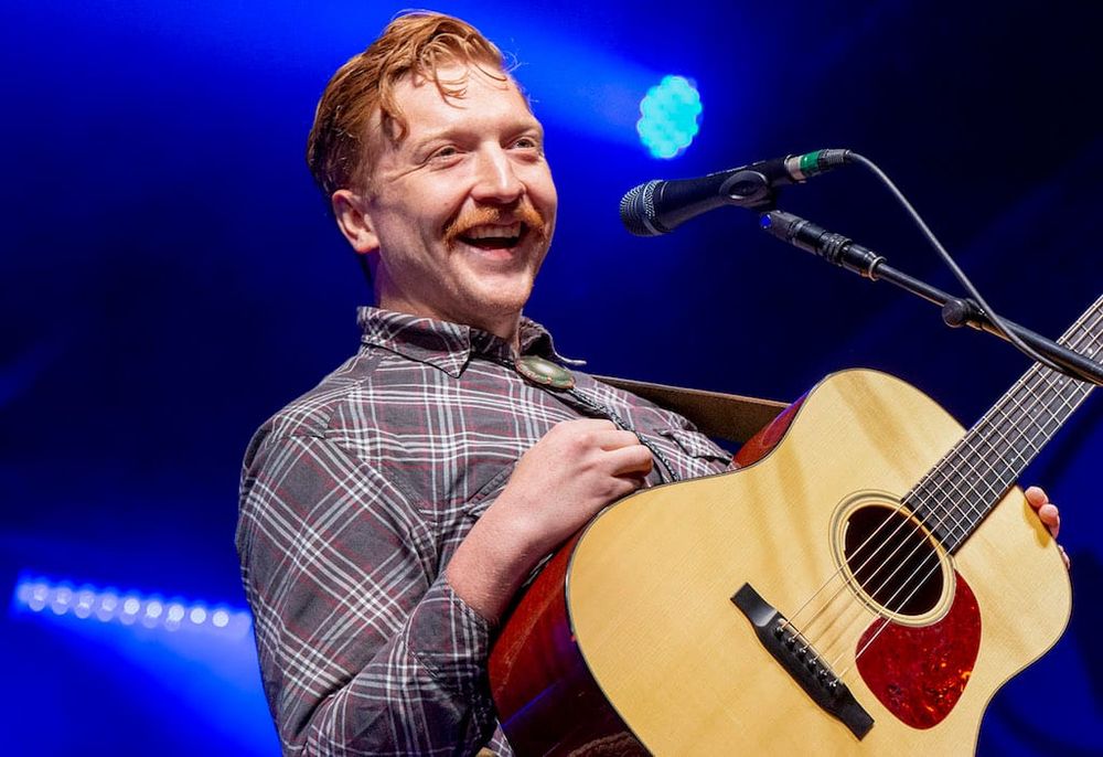 A picture of Tyler Childers, a ginger man with a mustache
