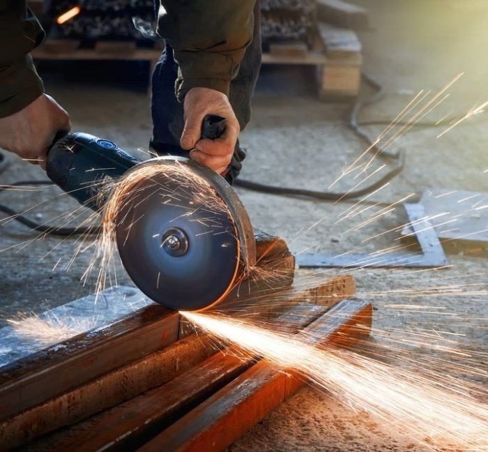 A steel I beam being cut with a saw. 