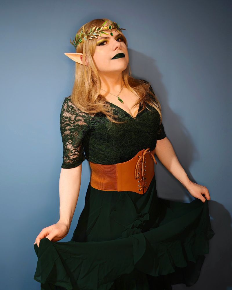 Aly as an elf, as with the previous post, but showing the whole outfit which also includes a brown leather effect waist belt. In this picture she's lifting the skirt portion of the dress up. It has not been ironed but that kind of adds to the "natural" look. I hope. 