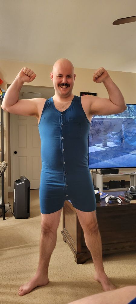 mustachioed cub in a short union suit